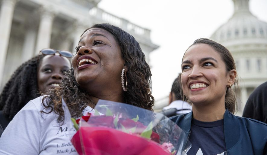 Rep. Cori Bush, D-Mo., and Rep. Alexandria Ocasio-Cortez, D-N.Y., smile after it was announced that the Biden administration will enact a targeted nationwide eviction moratorium outside of Capitol Hill in Washington on Tuesday, August 3, 2021. Lawmakers and activists primarily led by Rep. Cori Bush, D-Mo., sat on the steps of Capitol Hill to protest the expiration of the eviction moratorium. (AP Photo/Amanda Andrade-Rhoades) ** FILE **