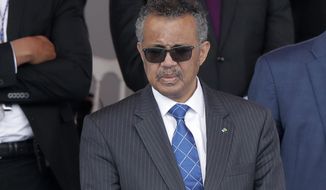 In this file photo dated Tuesday, July 14, 2020, Director-General of the World Health Organization Tedros Adhanom Ghebreyesus attends the Bastille Day military parade, in Paris.  The head of the World Health Organization has appealed on Wednesday, Aug. 4, 2021, for a moratorium on administering booster shots of COVID-19 vaccines, to ensure doses are available in countries where few people have yet received their first shots. (AP Photo/Christophe Ena, File)