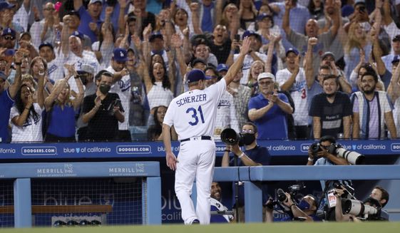 Los Angeles Dodgers starting pitcher Max Scherzer takes a curtain call during the seventh inning of a baseball game against the Houston Astros in Los Angeles, Wednesday, Aug. 4, 2021. Scherzer allowed 2 runs on 109 pitches, and struck out 10 Astro batters in seven innings of work. (AP Photo/Alex Gallardo)