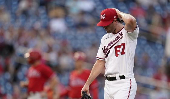 Washington Nationals relief pitcher Kyle Finnegan walks off the field in the middle of the ninth inning of a baseball game against the Philadelphia Phillies, Thursday, Aug. 5, 2021, in Washington. Philadelphia scored four runs against Finnegan in the ninth, and won 7-6. (AP Photo/Patrick Semansky)
