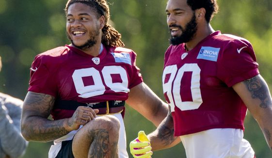 Washington Football Team defensive end Chase Young (99) and Washington Football Team linebacker Montez Sweat (90) at the team&#39;s NFL football training camp practice in Ashburn, Va., Thursday, Aug. 5, 2021. (AP Photo/Andrew Harnik)