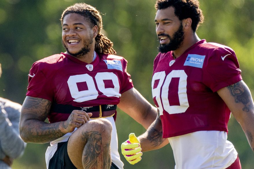 Washington Football Team defensive end Chase Young (99) and Washington Football Team linebacker Montez Sweat (90) at the team's NFL football training camp practice in Ashburn, Va., Thursday, Aug. 5, 2021. (AP Photo/Andrew Harnik) ** FILE **