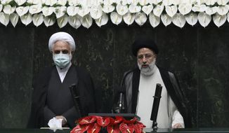 President Ebrahim Raisi, right, takes his oath as president, as Judiciary Chief Gholamhossein Mohseni Ejehi listens in a ceremony at the parliament in Tehran, Iran, Thursday, Aug. 5, 2021.  Raisi, a protégé of Iran&#39;s supreme leader, completes hard-liners&#39; dominance of all branches of government in the Islamic Republic. (AP Photo/Vahid Salemi)