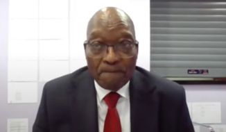 In this Monday, July 19, 2021, file frame grab provided by South Africa Judiciary, former South Africa President Jacob Zuma, appears on a screen virtually from the correctional service facility Estcourt, in Pietermaritzburg, South Africa, where his corruption trial resumed. Zuma has been admitted to the hospital for observation at a hospital outside the Estcourt Correctional Center where he is currently serving a 15-month jail sentence, the government announced on Friday, Aug. 6 2021. (South Africa Judiciary via AP)