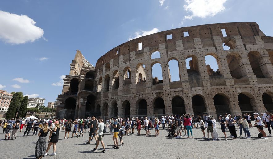 Tourists wait in a queue to enter the Colosseum in Rome, Italy, Friday, Aug. 6, 2021. (AP Photo/Riccardo De Luca)