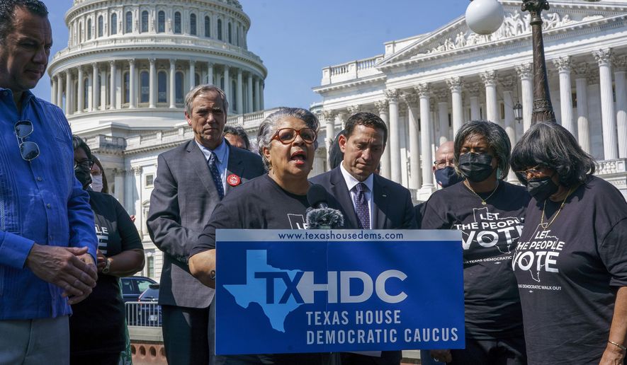Texas state Rep. Senfronia Thompson, dean of the Texas House of Representatives, is joined by Sen. Jeff Merkley, D-Ore., left center, and other Texas Democrats, as they continue their protest of restrictive voting laws, at the Capitol in Washington, Friday, Aug. 6, 2021. (AP Photo/J. Scott Applewhite) ** FILE **