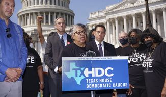 Rep. Senfronia Thompson, dean of the Texas House of Representatives, is joined by Sen. Jeff Merkley, D-Ore., left center, and other Texas Democrats, as they continue their protest of restrictive voting laws, at the Capitol in Washington, Friday, Aug. 6, 2021. (AP Photo/J. Scott Applewhite)
