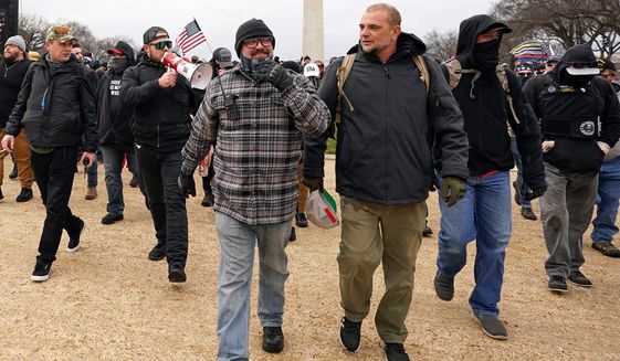 In this Jan. 6, 2021, file photo, Proud Boys including Joseph Biggs, front left, walks toward the U.S. Capitol in Washington, in support of President Donald Trump. With the megaphone is Ethan Nordean, second from left. Outside pressures and internal strife are roiling two far-right extremist groups after members were charged in the attack on the U.S. Capitol. Former President Donald Trump&#39;s lies about a stolen 2020 election united an array of right-wing supporters, conspiracy theorists and militants on Jan. 6. (AP Photo/Carolyn Kaster, File)