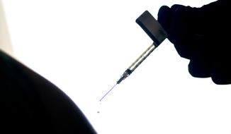 FILE - In this Dec. 15, 2020, file photo, a droplet falls from a syringe after a health care worker was injected with the Pfizer COVID-19 vaccine at a hospital in Providence, R.I.  An untold number of Americans have managed to get COVID-19 booster shots even though the U.S. government hasn&#39;t approved them. They&#39;re doing so by taking advantage of the nation’s vaccine surplus and loose tracking of those who have been fully vaccinated. (AP Photo/David Goldman, File)