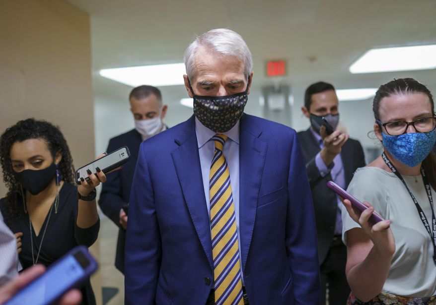 Sen. Rob Portman, R-Ohio, the top Republican negotiator on the bipartisan infrastructure bill, arrives for a procedural vote to advance the $1 trillion measure, at the Capitol in Washington, Saturday, Aug. 7, 2021. More votes will be needed before final Senate passage. (AP Photo/J. Scott Applewhite)