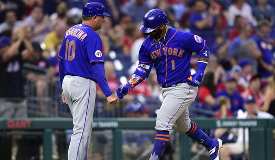 New York Mets&#39; Jonathan Villar, right, is congratulated by third base coach Gary Disarcina after hitting a solo home run off Philadelphia Phillies&#39; Mauricio Llovera during the ninth inning of a baseball game, Saturday, Aug. 7, 2021, in Philadelphia. (AP Photo/Derik Hamilton)