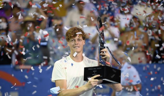 Jannik Sinner, of Italy, poses with the trophy after he beat Mackenzie McDonald, of the United States, during the singles final at the Citi Open tennis tournament Sunday, Aug. 8, 2021, in Washington. Sinner won 7-5, 4-6, 7-5. (AP Photo/Nick Wass)