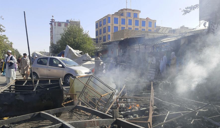 Smoke rises from damaged shops after fighting between Taliban and Afghan security forces in Kunduz city, northern Afghanistan, Sunday, Aug. 8, 2021. Taliban fighters Sunday took control of much of the capital of Kunduz province, including the governor's office and police headquarters, a provincial council member said. (AP Photo/Abdullah Sahil)