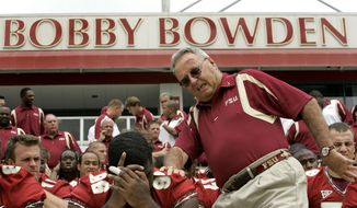 In this Aug. 12, 2007, file photo, Florida State head football coach Bobby Bowden, right, squeezes into his seat for a team photo during media day activities in Tallahassee, Fla. The Hall of Fame college football coach Bobby Bowden has died after a battle with pancreatic cancer. Exuding charm and wit, Bowden led Florida State to two national championships and a record of 315-98-4 during his 34 seasons with the Seminoles. In all, Bowden had 377 wins during his 40 years in major college coaching. He was 91 years old. (AP Photo/Phil Coale, File) **FILE**