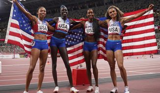 The United States team of Allyson Felix, Athing Mu, Dalilah Muhammad and Sydney Mclaughlin, from left, celebrate winning the gold medal in the final of the women&#39;s 4 x 400-meter relay at the 2020 Summer Olympics, Saturday, Aug. 7, 2021, in Tokyo, Japan. (AP Photo/Charlie Riedel)