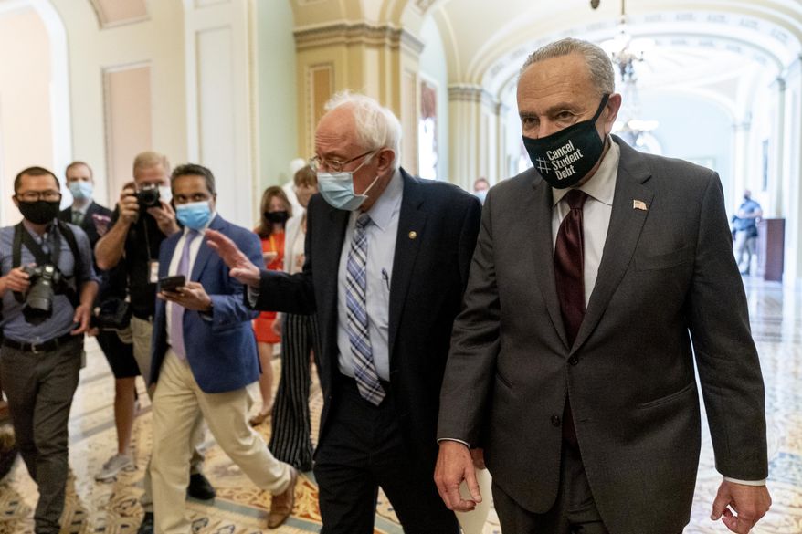 Sen. Bernie Sanders, I-Vt., left, and Senate Majority Leader Chuck Schumer of N.Y., right, speak to members of the media as they walk out of a budget resolution meeting at the Capitol in Washington, Monday, Aug. 9, 2021. (AP Photo/Andrew Harnik)