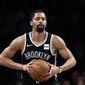In this March 4, 2020, file photo, Brooklyn Nets guard Spencer Dinwiddie looks to pass the ball during the team&#39;s NBA basketball game against the Memphis Grizzlies in New York. The Washington Wizards have agreed to a $62 million, three-year deal with Dinwiddie, according to a person with knowledge of the agreement. The person, who spoke to The Associated Press on condition of anonymity Wednesday, Aug. 4, because the deal had not been announced, said Dinwiddie is heading to the Wizards in a sign-and-trade. (AP Photo/Kathy Willens, File) **FILE**