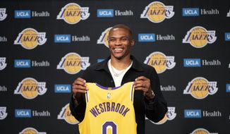 Los Angeles Lakers guard Russell Westbrook poses for a photo with his jersey at an introductory NBA basketball news conference in Los Angeles, Tuesday, Aug. 10, 2021. (AP Photo/Kyusung Gong) **FILE**