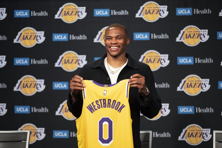 Los Angeles Lakers guard Russell Westbrook poses for a photo with his jersey at an introductory NBA basketball news conference in Los Angeles, Tuesday, Aug. 10, 2021. (AP Photo/Kyusung Gong) **FILE**