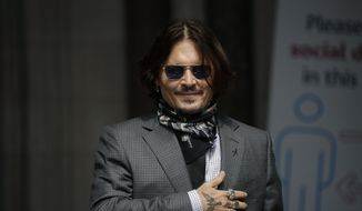 In this Thursday, July 23, 2020, file photo, U.S. actor Johnny Depp gestures to fans and the media as he arrives at the High Court in London. Spain’s most high-profile group of female filmmakers denounced the San Sebastian film festival’s decision to award Depp its highest honor for acting on Monday, Aug. 9, 2021. (AP Photo/Matt Dunham, file)