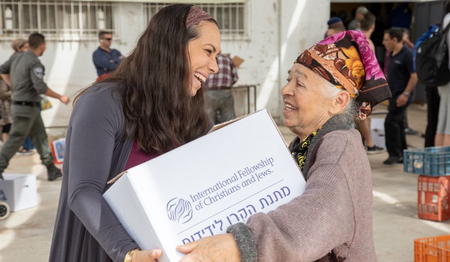 Yael Eckstein, president and CEO of the International Fellowship of Christians &amp; Jews, speaks with an elderly Jewish aid recipient in Israel. (Photo courtesy of International Fellowship of Christians &amp; Jews)