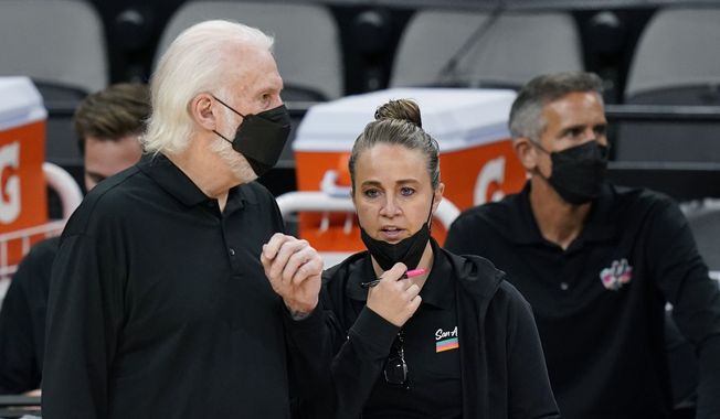 San Antonio Spurs head coach Gregg Popovich, left, talks with assistant coach Becky Hammon during the second half of an NBA basketball game against the Orlando Magic in San Antonio, in this Friday, March 12, 2021, file photo. Hammon can&#x27;t wait for the time when it&#x27;s the norm for females to interview for head coaching positions in the NBA and their gender isn&#x27;t the story. Hammon&#x27;s entering her eighth season as an assistant and has been interviewed for several head coach positions but hasn&#x27;t gotten an offer yet to be the first female to lead a NBA team. (AP Photo/Eric Gay, File) **FILE**