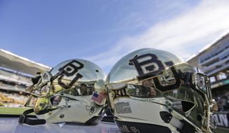 In this Dec. 5, 2015, file photo, Baylor helmets on shown the field after an NCAA college football game in Waco, Texas. The NCAA infractions committee said Wednesday, Aug. 11, 2021, that its years-long investigation into the Baylor sexual assault scandal would result in four years probation and other sanctions, though the “unacceptable” behavior at the heart of the case did not violate NCAA rules.(AP Photo/LM Otero, File) **FILE**