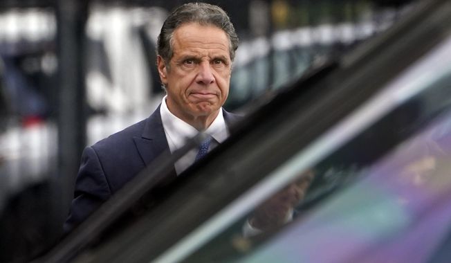 New York Gov. Andrew Cuomo prepares to board a helicopter after announcing his resignation, Tuesday, Aug. 10, 2021, in New York. Cuomo says he will resign over a barrage of sexual harassment allegations. The three-term Democratic governor&#x27;s decision, which will take effect in two weeks, was announced as momentum built in the Legislature to remove him by impeachment. (AP Photo/Seth Wenig)