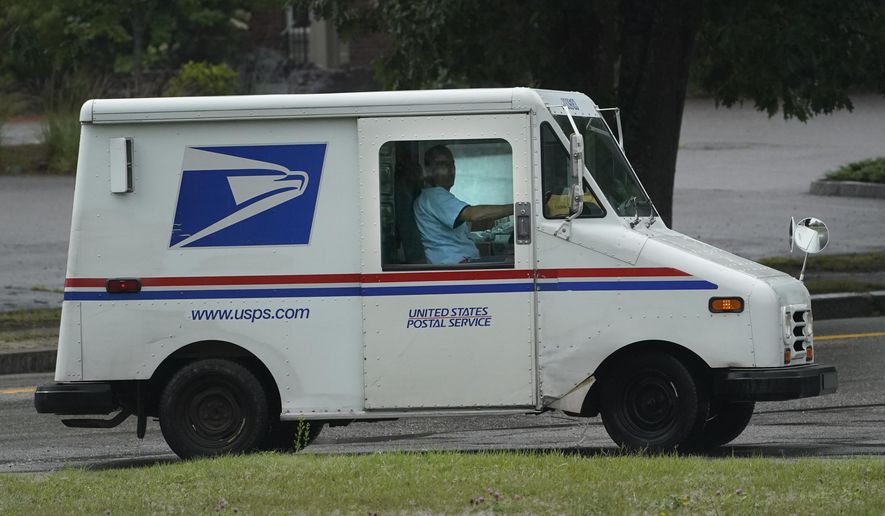 U.S. Postal Service carrier John Graham drives a 28-year-old delivery truck while making rounds in Wednesday, July 14, 2021, in Portland, Maine. (AP Photo/Robert F. Bukaty) **FILE**
