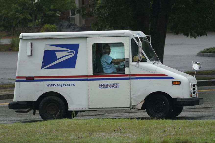 U.S. Postal Service carrier John Graham drives a 28-year-old delivery truck while making rounds in Wednesday, July 14, 2021, in Portland, Maine. (AP Photo/Robert F. Bukaty) **FILE**