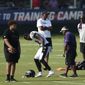 Baltimore Ravens&#x27; Rashod Bateman limps off the field during an NFL football practice, Tuesday, Aug. 10, 2021 in Owings Mills, Md.(AP Photo/Gail Burton) **FILE**