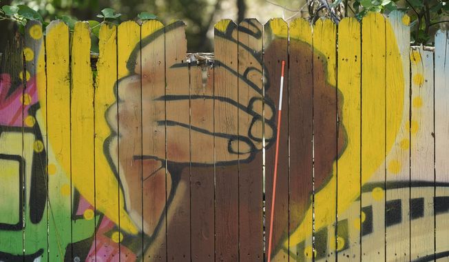 A mural on a fence is displayed at United Fort Worth, a grassroots community organization in Fort Worth, Texas, Tuesday, Aug. 10, 2021. (AP Photo/LM Otero).