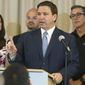 In this Aug. 10, 2021, file photo, Florida Gov. Ron DeSantis answers questions related to school openings and the wearing of masks in Surfside, Fla. Top Republicans are battling school districts in their own states’ urban, heavily Democratic areas over whether students should be required to mask up as they head back to school. (AP Photo/Marta Lavandier) ** FILE **