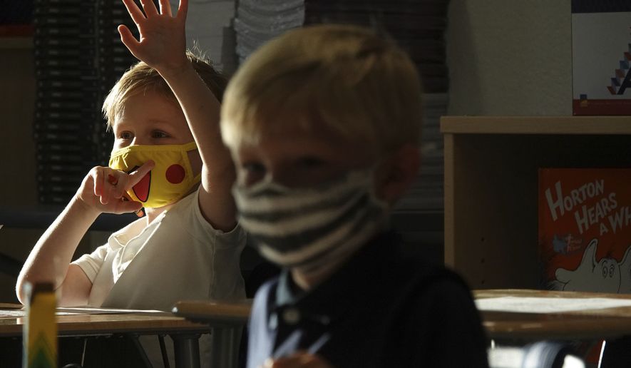 First Graders Alex Albin, left, and Tyler Custodio wear masks in Amanda McCoy&#x27;s first grade class at the newly-rebuilt Addison Mizner School in Boca Raton, Tuesday, Aug. 10, 2021. Palm Beach County Schools opened the school year with a masking requirement with an opt-out option. (Joe Cavaretta/South Florida Sun-Sentinel via AP)