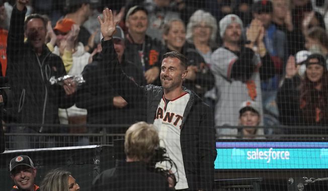 Former NFL quarterback Alex Smith waves to fans while being introduced during a baseball game between the San Francisco Giants and the Colorado Rockies in San Francisco, Friday, Aug. 13, 2021. (AP Photo/Jeff Chiu) ** FILE **