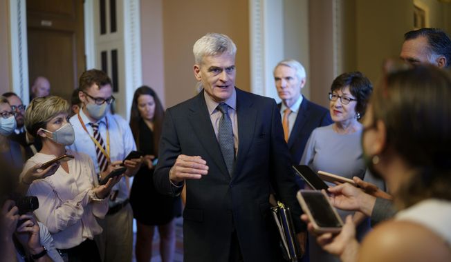 Sen. Bill Cassidy, R-La., center, and other Senate Republicans negotiating a $1 trillion infrastructure bill with Democrats, announce they have reached agreement on the major outstanding issues and are ready to vote to take up the bill, at the Capitol in Washington, Wednesday, July 28, 2021. (AP Photo/J. Scott Applewhite)