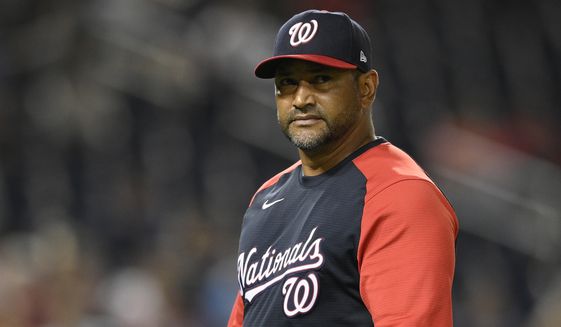 Washington Nationals manager Dave Martinez walks back to the dugout after a pitching change during a baseball game against the Atlanta Braves early Saturday, Aug. 14, 2021, in Washington. (AP Photo/Nick Wass)