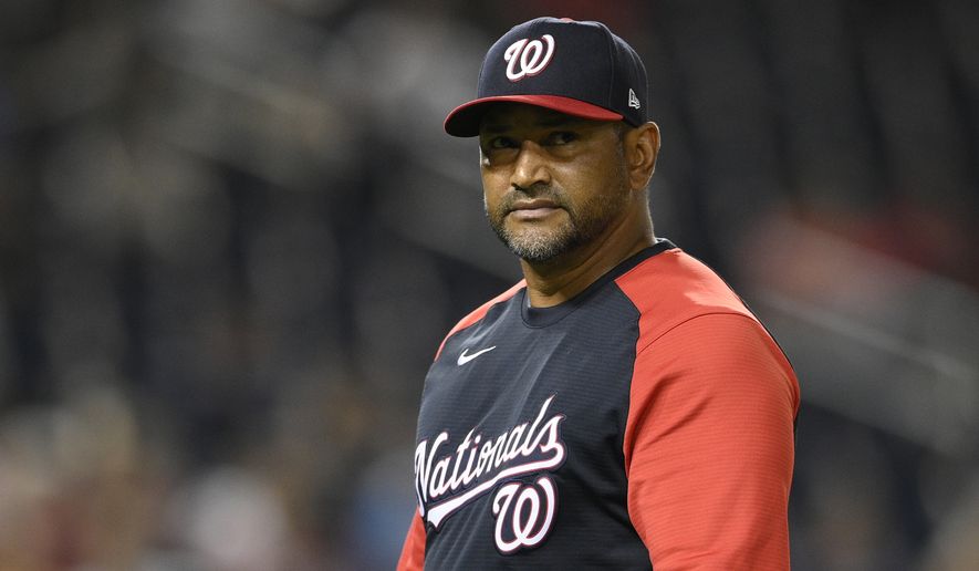Washington Nationals manager Dave Martinez walks back to the dugout after a pitching change during a baseball game against the Atlanta Braves early Saturday, Aug. 14, 2021, in Washington. (AP Photo/Nick Wass)