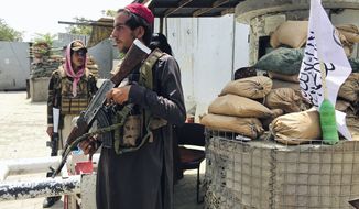Taliban fighters stand guard at a checkpoint near the US embassy that was previously manned by American troops, in Kabul, Afghanistan, Tuesday, Aug. 17, 2021. The Taliban declared an &quot;amnesty&quot; across Afghanistan and urged women to join their government Tuesday, seeking to convince a wary population that they have changed a day after deadly chaos gripped the main airport as desperate crowds tried to flee the country. (AP Photo)