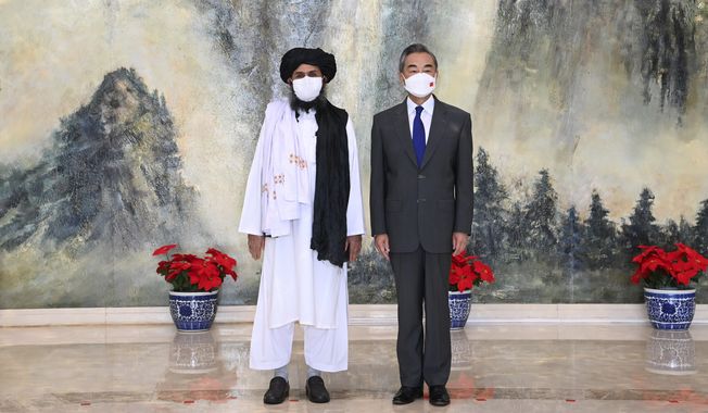 In this  July 28, 2021, file photo released by China&#x27;s Xinhua News Agency, Taliban co-founder Mullah Abdul Ghani Baradar, left, and Chinese Foreign Minister Wang Yi pose for a photo during their meeting in Tianjin, China.  (Li Ran/Xinhua via AP, File)  **FILE**