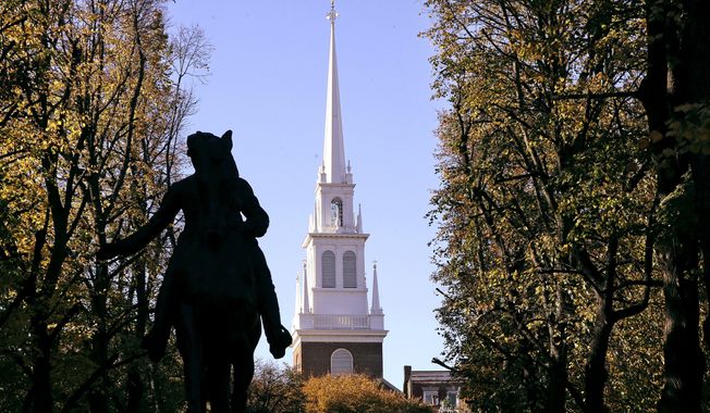 In this Nov. 7, 2018, file photograph, the Old North Church stands behind a statue of Paul Revere in the North End neighborhood of Boston. The church is famous as the place where in 1775 two lanterns in the steeple signaled that the British were heading to Concord and Lexington, but it&#x27;s not well known that some of the church&#x27;s early congregants were slave holders. Now the church, with a grant from the National Endowment for the Humanities, is integrating that history into its educational mission. (AP Photo/Steven Senne, File)