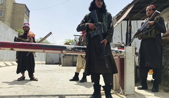 Taliban fighters stand guard at a checkpoint near the US embassy that was previously manned by American troops, in Kabul, Afghanistan, Tuesday, Aug. 17, 2021. The Taliban declared an &amp;quot;amnesty&amp;quot; across Afghanistan and urged women to join their government Tuesday, seeking to convince a wary population that they have changed a day after deadly chaos gripped the main airport as desperate crowds tried to flee the country. (AP Photo)