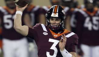 Virginia Tech quarterback Braxton Burmeister throws a pass during the first half against Clemson in an NCAA college football game in Blacksburg, Va., in this Saturday, Dec. 5, 2020, file photo. Few Power Five programs struggled through the pandemic more than Virginia Tech. Coach Justin Fuente and the Hokies hope to restore some order this season. (Matt Gentry/The Roanoke Times via AP, Pool, File) **FILE***