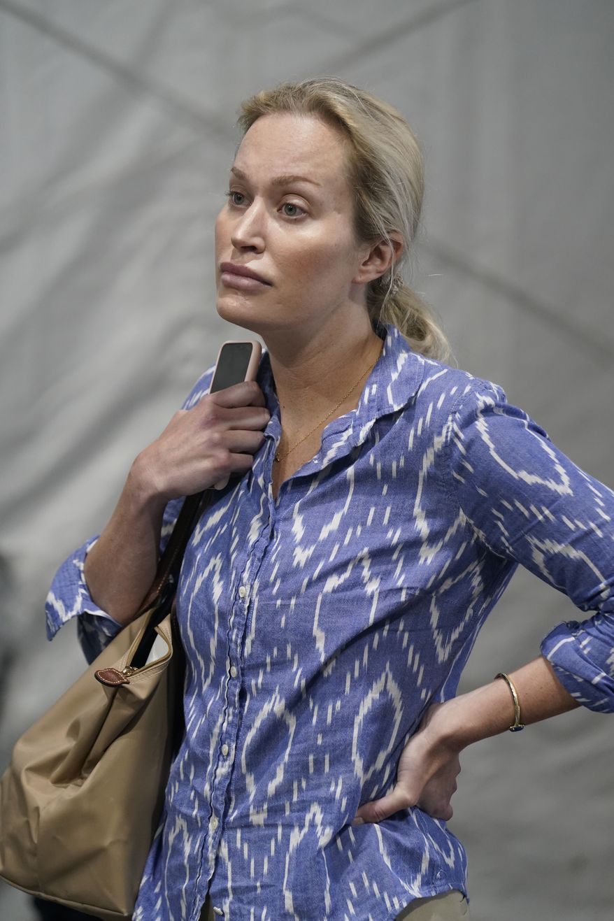 Christina Pushaw, press secretary for Florida Gov. Ron DeSantis, listens during a press conference, Wednesday, Aug. 18, 2021, in Pembroke Pines, Fla. (AP Photo/Marta Lavandier)