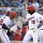 Washington Nationals&#39; Josh Bell celebrates his three-run home run with Juan Soto (22) and Alcides Escobar (3) during the seventh inning of a baseball game against the Toronto Blue Jays, Wednesday, Aug. 18, 2021, in Washington. The Nationals won 8-5. (AP Photo/Nick Wass)