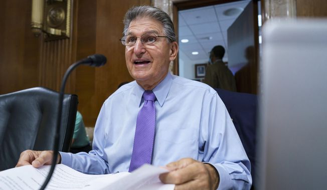 In this Aug. 5, 2021 photo, Sen. Joe Manchin, D-W.Va., prepares to chair a hearing in the Senate Energy and Natural Resources Committee, as lawmakers work to advance the $1 trillion bipartisan bill, at the Capitol in Washington. (AP Photo/J. Scott Applewhite)