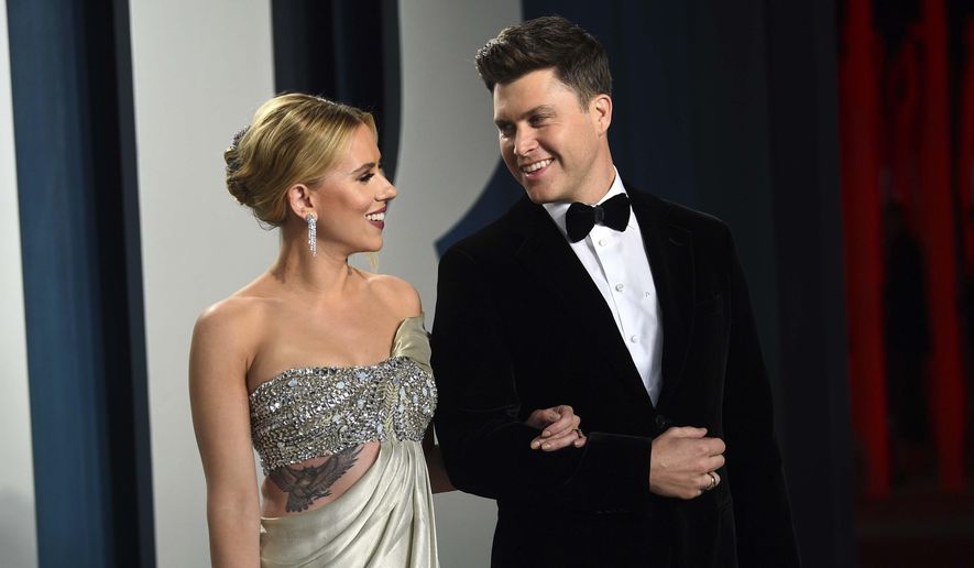 In this Feb. 9, 2020, file photo, Scarlett Johansson, left, and Colin Jost arrive at the Vanity Fair Oscar Party in Beverly Hills, Calif. Johansson is a mom to two now. The “Black Widow” star recently gave birth to a son, Cosmo, with husband Colin Jost, the “Saturday Night Live” star said on Instagram Wednesday, Aug. 18, 2021. This is the first child for the couple, who were married last October. (Photo by Evan Agostini/Invision/AP, File)