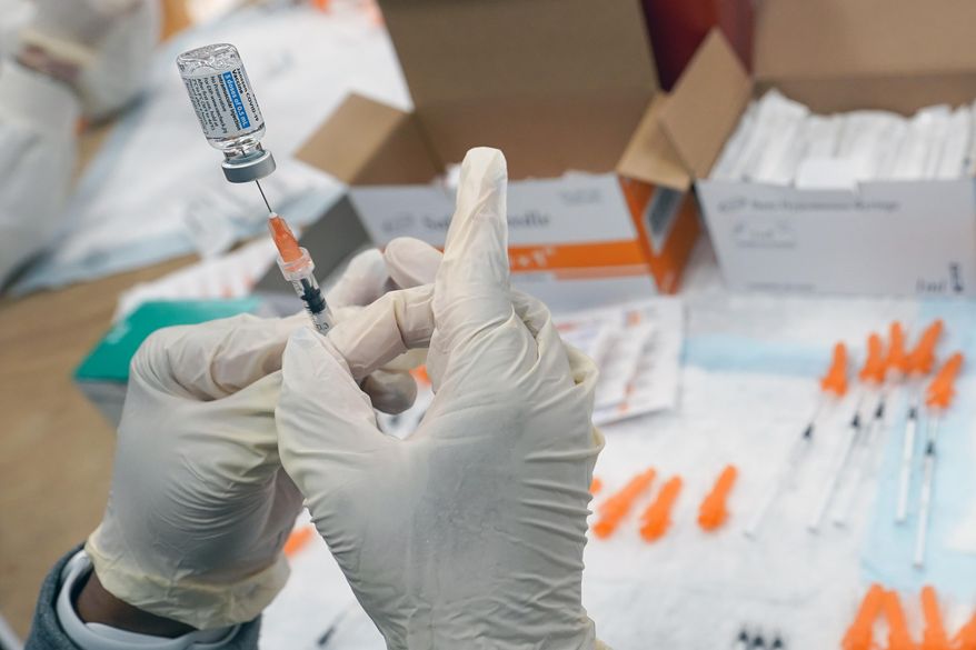In this April 8, 2021, file photo, a registered nurse fills a syringe with the Johnson & Johnson COVID-19 vaccine at a pop-up vaccination site in the Staten Island borough of New York. Researchers and health officials have been monitoring the real-world performance of the COVID-19 vaccines to see how long protection lasts among vaccinated people. (AP Photo/Mary Altaffer, File)