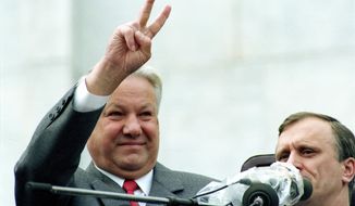 FILE - In this Thursday, Aug. 22, 1991 file photo, Russian Republic President Boris Yeltsin makes a V-sign to thousands of Muscovites during a rally in front of the Russian federation building to celebrate the failed military coup in Moscow, Russia. In the capital, where thousands of protesters confronted soldiers on tanks and armed personnel carriers, Yeltsin climbed atop one military vehicle and urged the Russian people to fight back with an immediate general strike. (AP Photo/Boris Yurchenko, File)
