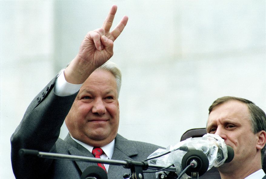 FILE - In this Thursday, Aug. 22, 1991 file photo, Russian Republic President Boris Yeltsin makes a V-sign to thousands of Muscovites during a rally in front of the Russian federation building to celebrate the failed military coup in Moscow, Russia. In the capital, where thousands of protesters confronted soldiers on tanks and armed personnel carriers, Yeltsin climbed atop one military vehicle and urged the Russian people to fight back with an immediate general strike. (AP Photo/Boris Yurchenko, File)